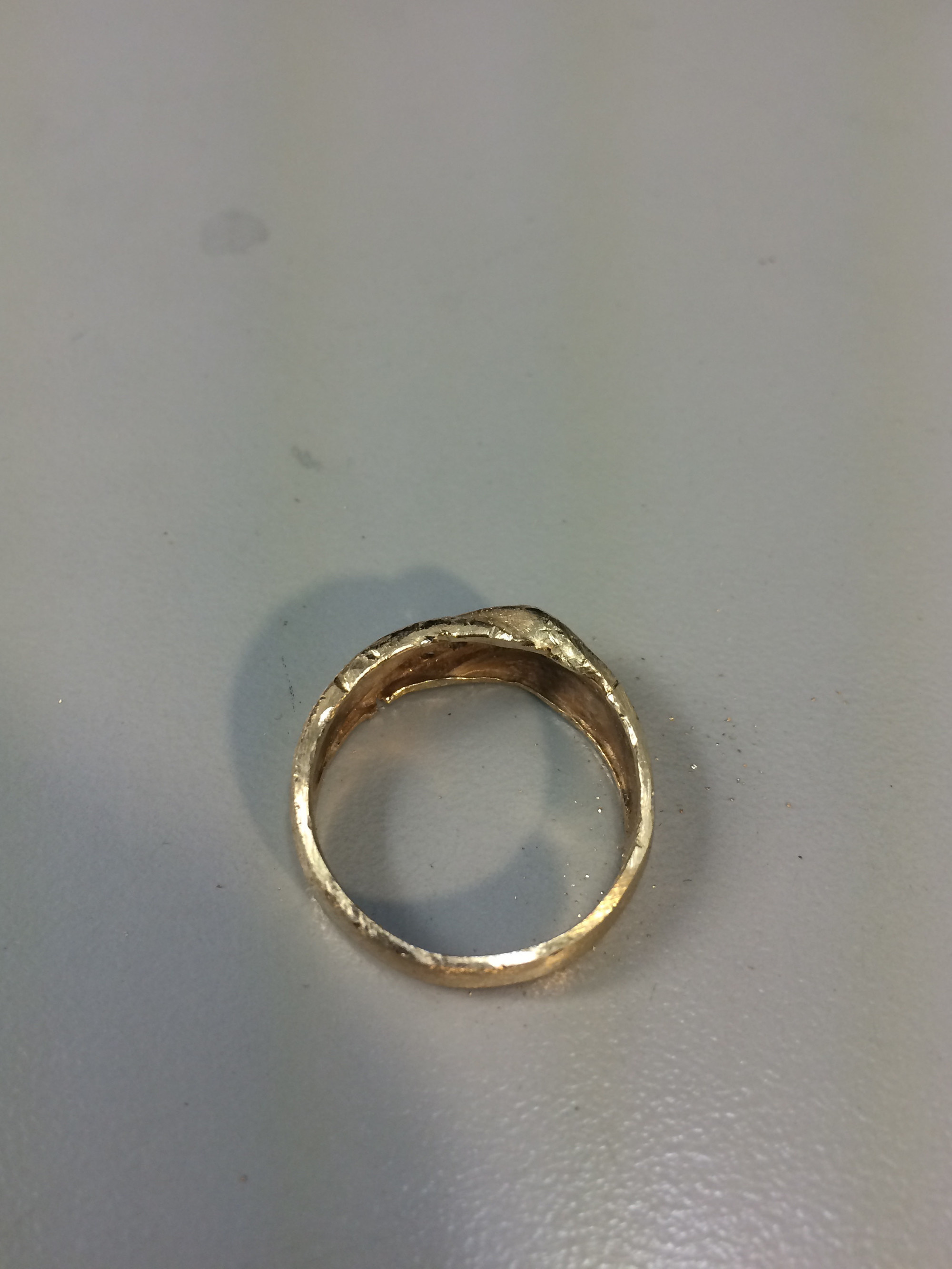 This step can remove a lot of gold from the ring, so he was careful to focus on filing and refurbishing only the mild scratches.