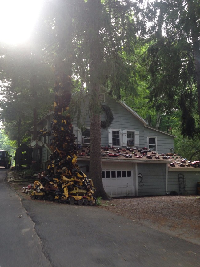 An army of tiny cars litters the roof of this home, and no one knows why.