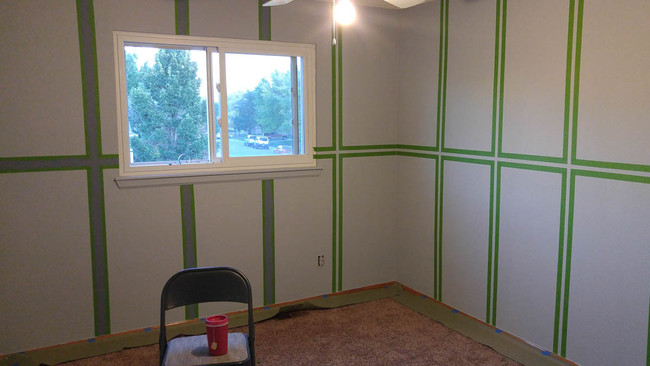 After the walls were primed and painted, they mapped out the desired pattern with tape.