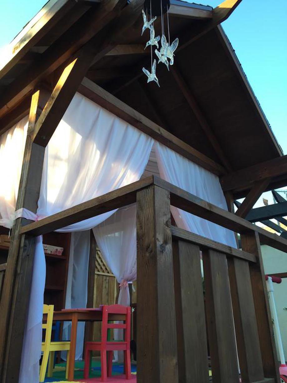 "Everything that went into this is more clear in the video, but I stained the playhouse and put up pink mosquito netting for the girls and some solar powered hummingbird chime lights, because I'm like that."