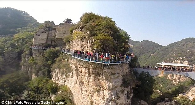 Glass-bottomed walkways have become incredibly popular for Chinese thrill-seekers. Pictured is a similar attraction on Tianyun Mountain, Beijing