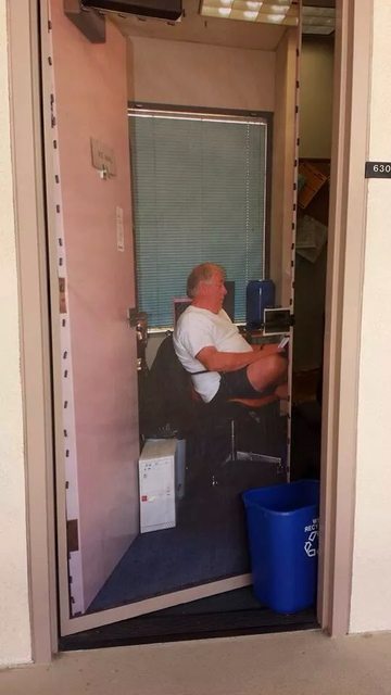 Professor is never in his office so he put a giant poster of himself on the door
