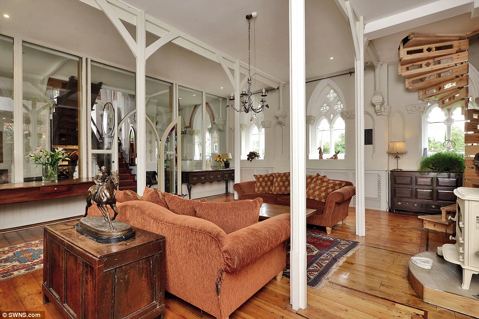 Sitting room: The Grade II-listed building, on the market for £450,000, includes the church atrium and an ornate stone lychgate