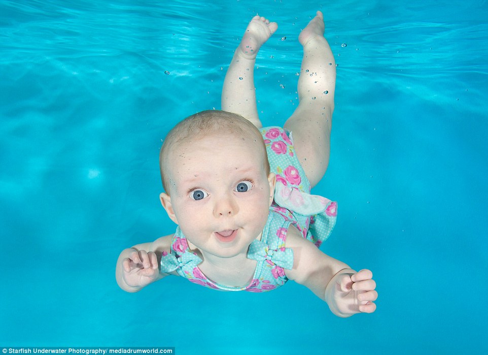 Expressive Rose, seven months old, at an underwater photoshoot with Aquatots Swim School in Cheltenham, seems to be enjoying her underwater experience 
