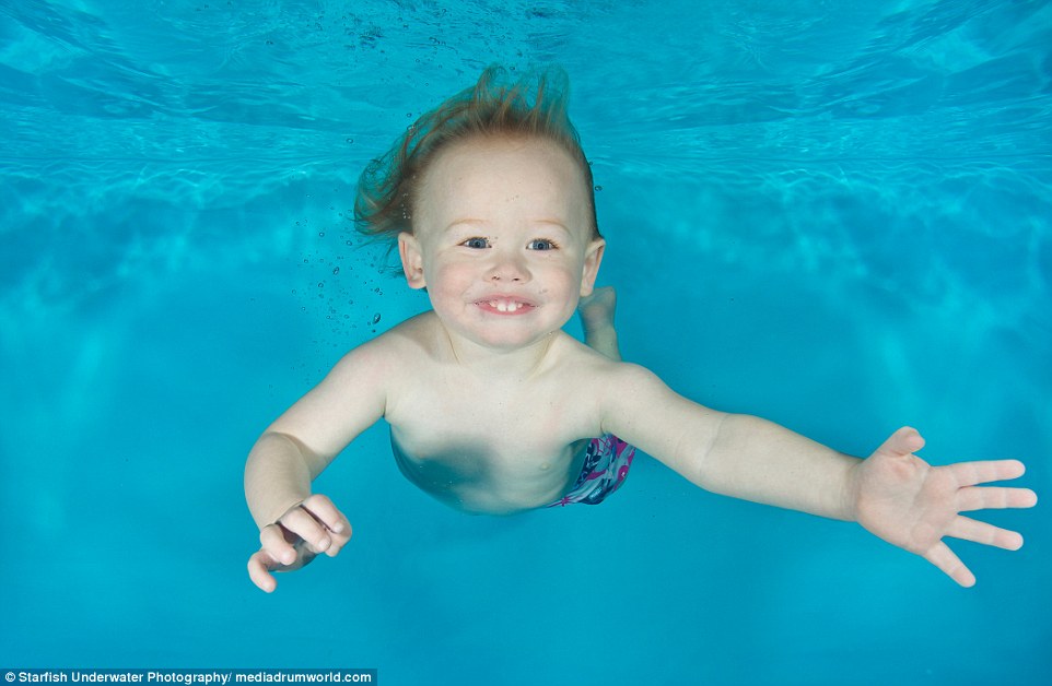 Ryan, two, at Tadpole Tots Swim School in Farnham, Surrey, is among the images of toddlers at their most playful and pure as they dive down into the deep during their swimming lessons