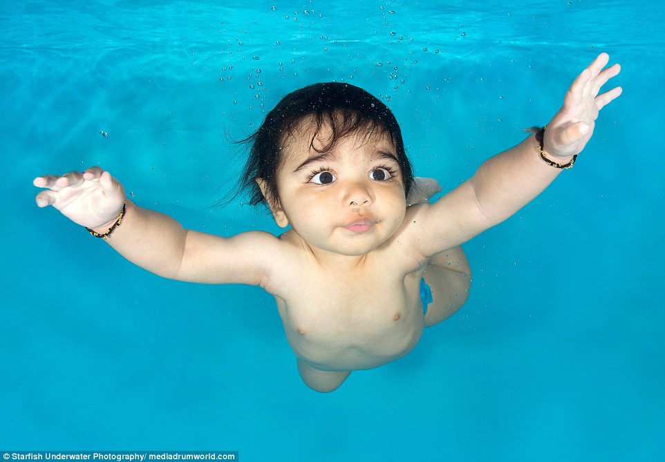 Aarav, 6 months old, at an underwater photo shoot with Little Fishes Swim School in Bushey, Hertfordshire, is one of the adorable babies as young as three months who feature