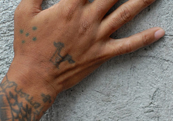 Five dots

These dots differ greatly from the previous tattoo – five dots represents time done in prison. Also known as the quincunx, the four dots on the outside represent four walls, with the fifth on the inside representing the prisoner. This tattoo can be found internationally, among both American and European inmates. The dots are typically found on an inmate’s hand, between the thumb and forefinger.