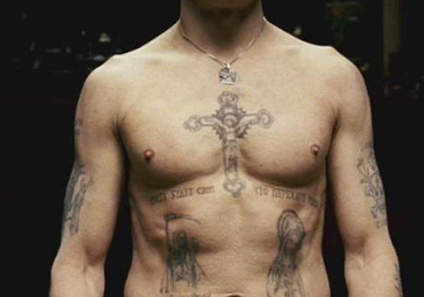 Cross on the chest

Particularly found in Russian prisons, chest tattoos symbolize a ‘Prince of Thieves.’ This is the highest rank a Russian convict can achieve, and are generally worn by higher-ups in the mob. Russian prisons have a unique and intricate history of prison tattoos, each with their own unique meaning. Another example are bells, symbolizing freedom, or a tiger on the chest is symbolic of aggression toward the police.