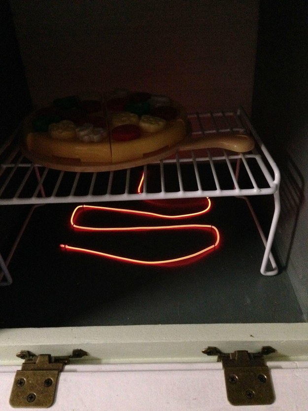 Oh, fun side note, the kitchen even comes with electroluminescent wire "burners" hooked up to a battery with an on-and-off button. So Owen can actually turn his stove on.