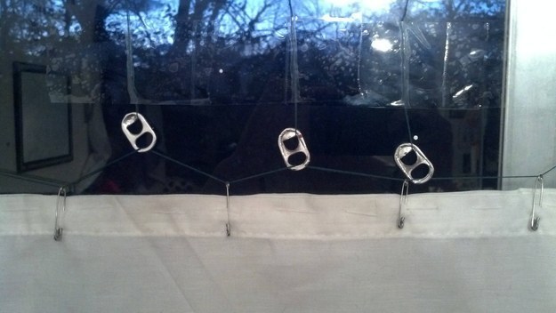 Who needs curtain hooks when you can use the rings from Coke cans? Just as stylish at a fraction of the cost.