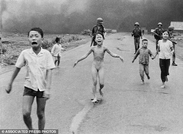 In this June 8, 1972 photo, nine-year-old Kim Phuc, center, runs with her brothers and cousins, followed by South Vietnamese forces, down Route 1 near Trang Bang after a South Vietnamese plane accidentally dropped its flaming napalm on its own troops and civilians. The terrified girl had ripped off her burning clothes while fleeing.