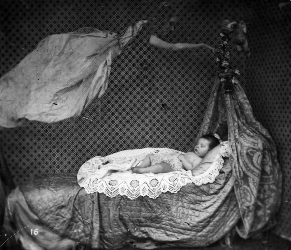 A midnight haunting over a baby's crib, circa 1860.