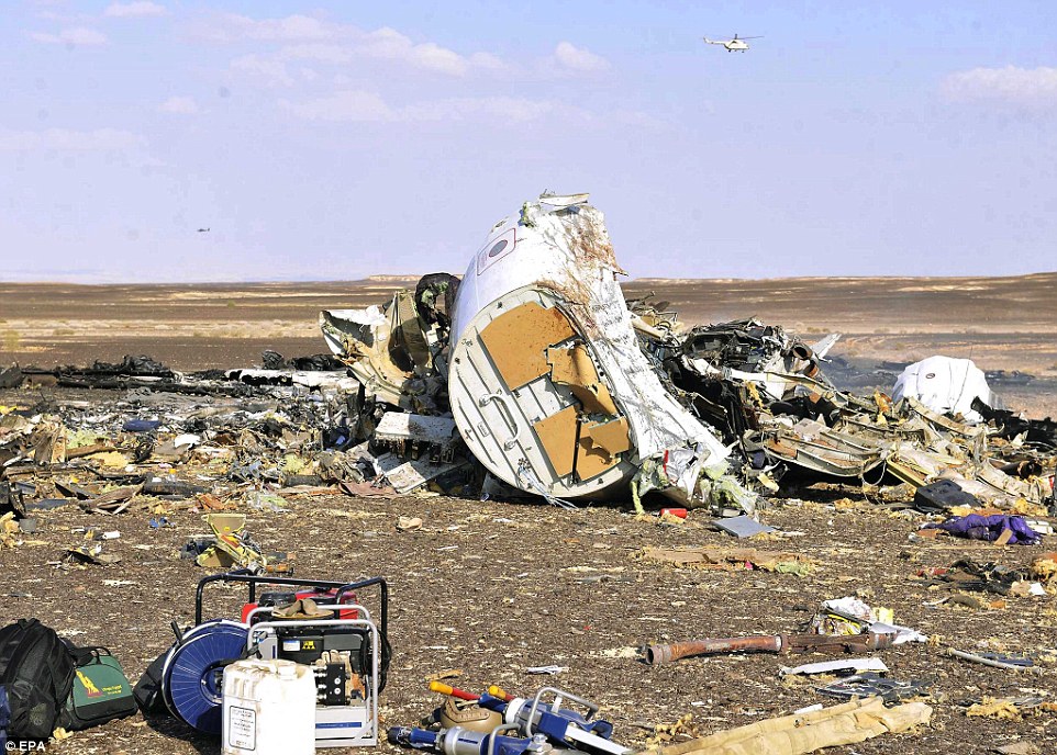 Devastating: Passengers' belongings, pieces of metal and other bits of the aircraft lay strewn across the sand following the deadly crash