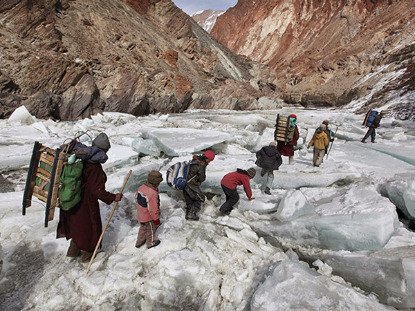 These kids are walking over ice to a boarding school in the Himalayas.