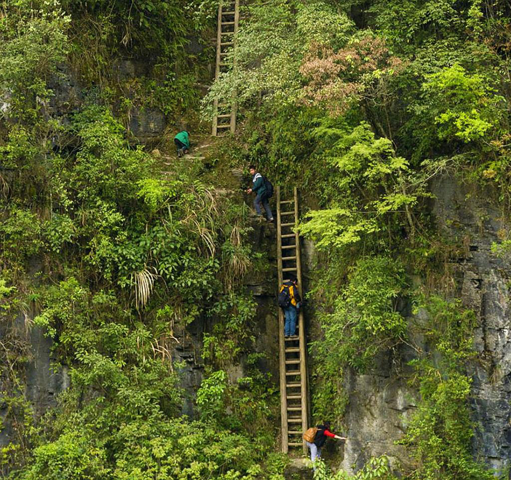 Students must climb an unsecured wooden ladder in Zhang Jiawan Village, Souther China, to get to class.