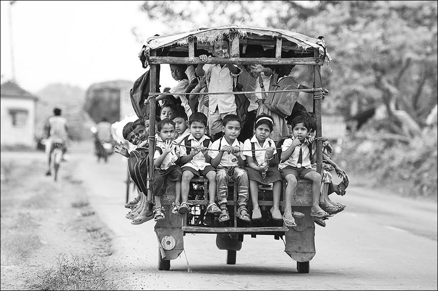 In Beldanga, India, kids ride  Tuktuk or 'Auto RickShaw' to school.