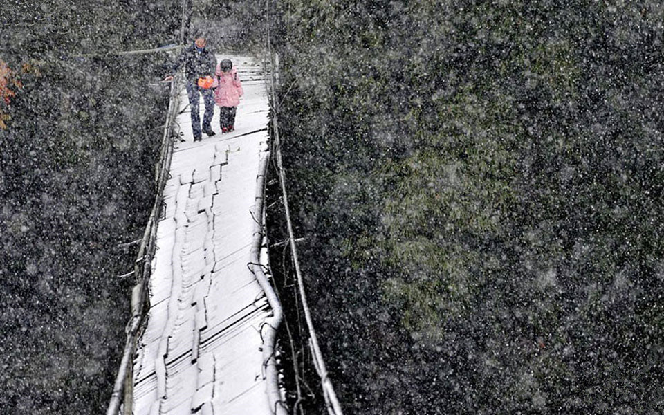 This student has to cross a broken bridge in the snow to get to school in Dujiangyan, Sichuan Province, China.
