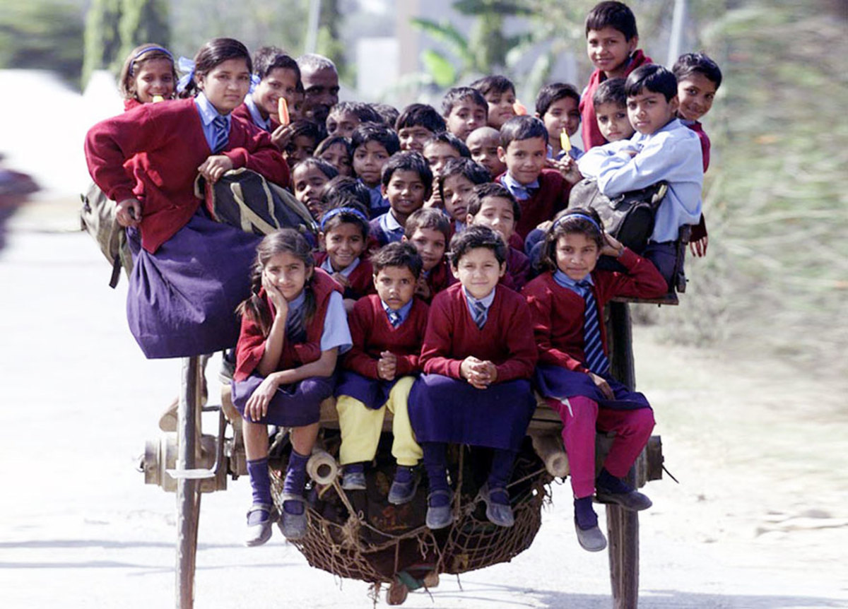 If it has wheels, you ride it to school. Children in Delhi, India love riding the horse cart to school.