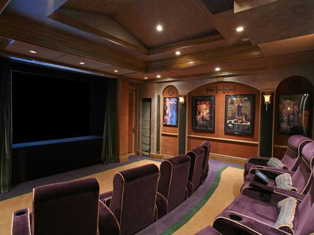 The home theater can accommodate 20 guests in plush seats.