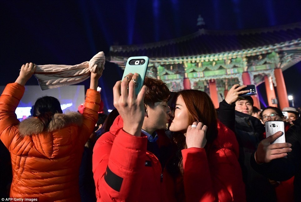 In South Korea, a couple took a selfie while sharing a midnight kiss. They're at the Imjingak Peace Park in Paju.