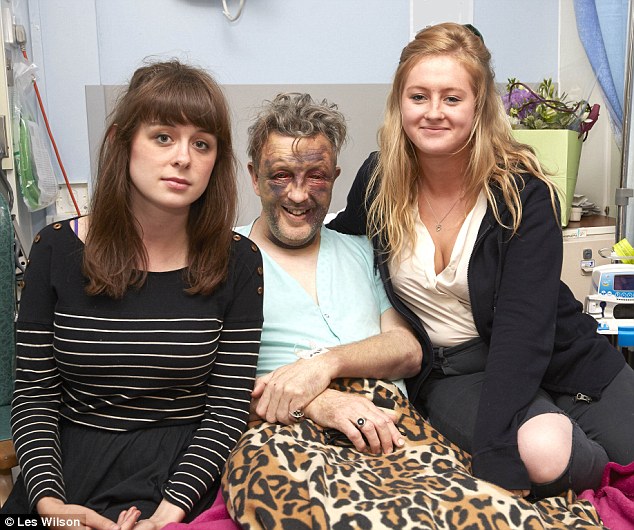 Still smiling: Paul Kohler, who was left battered by his attackers, with daughters Eloise (left) and Bethany (right)