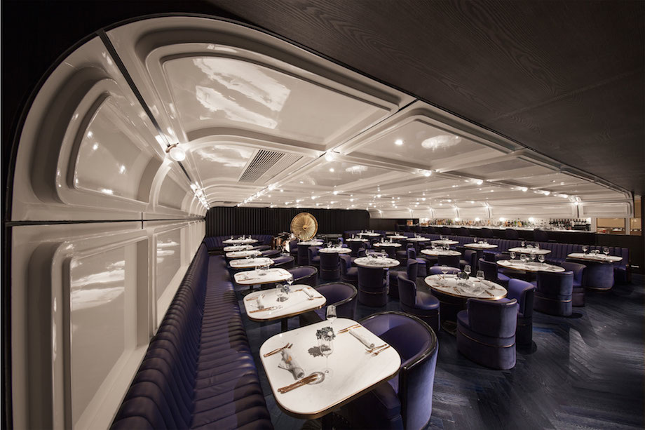 The first room is reminiscent of first class airplane cabins with curved ceilings and glossy white walls.