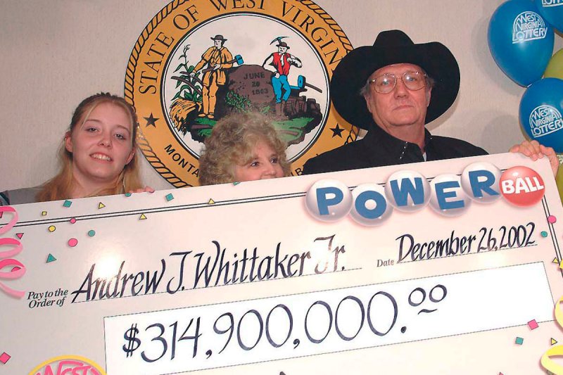 West Virginia Gov. Bob Wise, right, presents powerball jackpot winner Andrew "Jack" Whittaker, Jr., center right, and his wife Jewell, center, granddaughter Brandi Bragg, center left, and daughter Ginger McMahan, left, with a check at a news conference in Charleston, W.Va., Thursday, Dec. 26, 2002. Whittaker, a 55-year-old contractor won the $314.9 million Christmas Day jackpot. (AP Photo/Bob Bird)