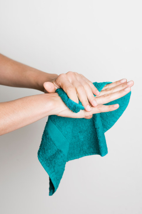 Everyone drying their hands on the same hand towel.