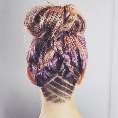 messy braids and bun hairstyle with shaved nape design