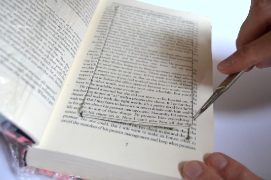 Take an old book you no longer read and cut out a hole in the pages to create a storage unit there. 