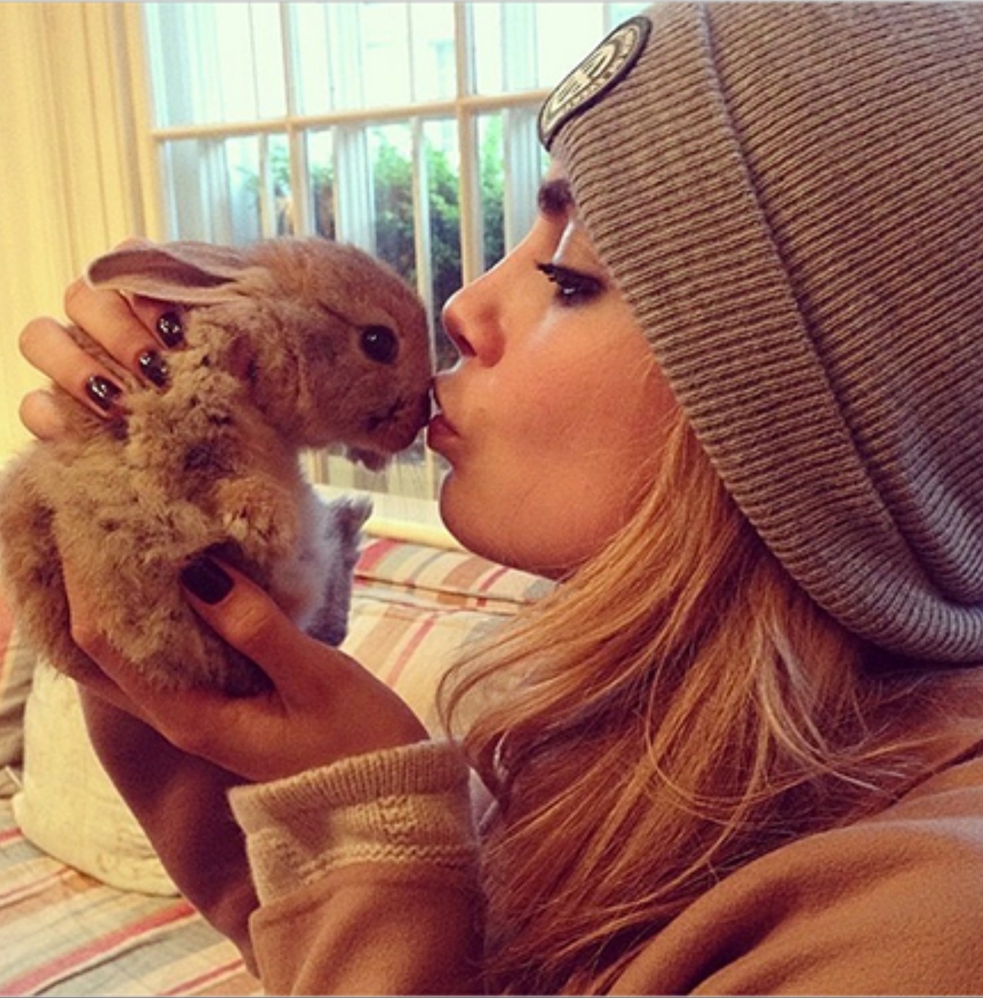 Cara Delevingne smooches 'Cecil Bunny Delevingne.' Cecil is on Instagram and has over 7K followers!