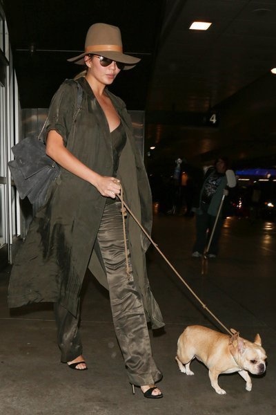 Chrissy Teigen shown with her adorable best friend at LAX on November 17, 2015.