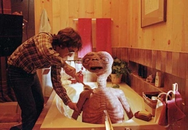 E.T. the Extra-Terrestial getting a much deserved bath from director Steven Spielberg.