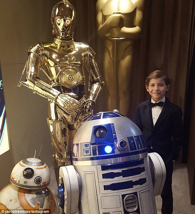 'My new squad!' Jacob Tremblay poses with the Star Wars droids at the Oscars on Sunday