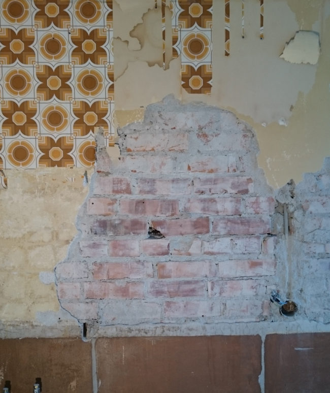 But then he noticed some bricks under the plaster that had been hidden for decades.