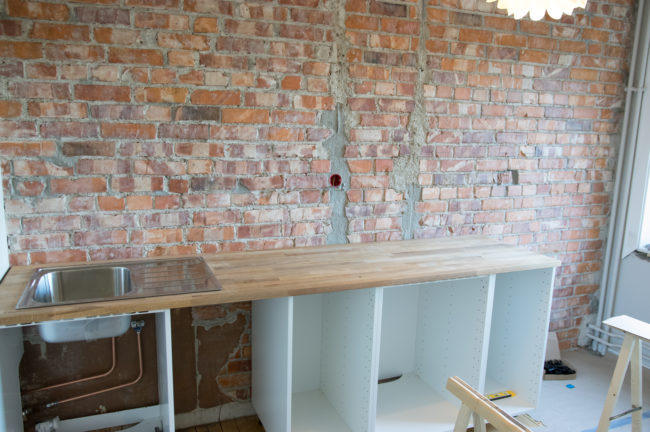 Once the brick was fully exposed, he worked on the countertop and cabinets.
