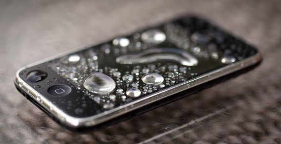 Use silica gel to absorb water inside your phone, it's more effective than rice.