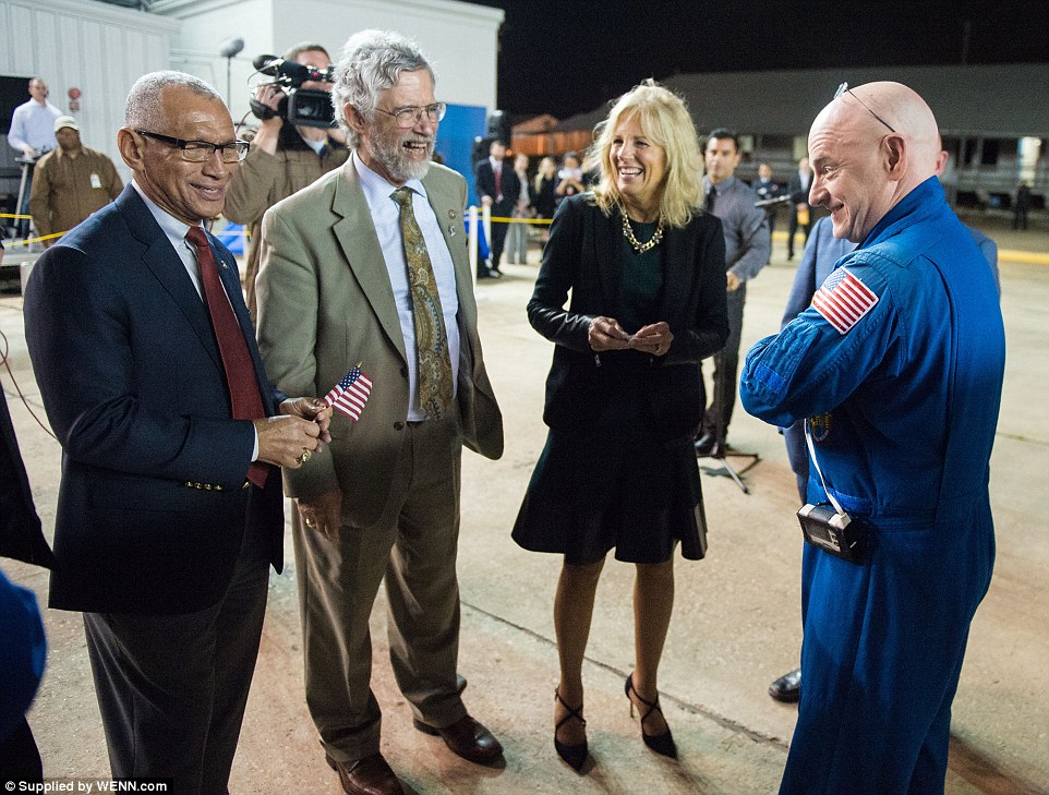 Scott Kelly, right, is seen with Nasa Administrator Charles Bolden, left, Dr John Holdren, director of the White House Office of Science and Technology, second from left, and Dr Jill Biden, wife of Vice President Joe Biden, second from right, after returning to Ellington Field