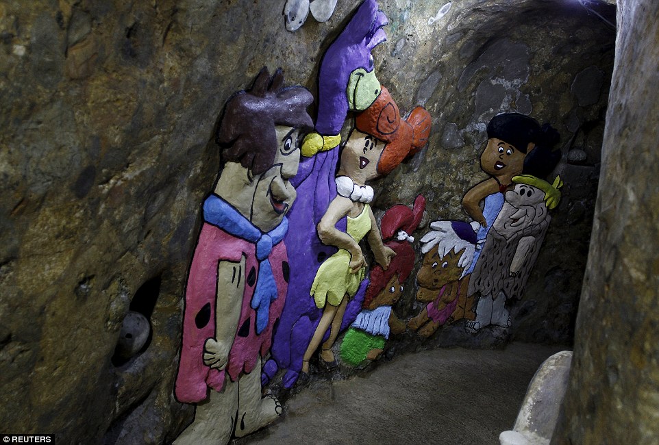 Colourful characters from the cartoon The Flintstones are painted in one of the cave's hallway