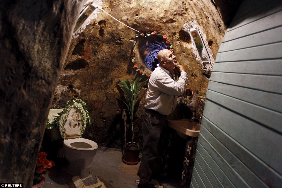 Manuel Barrantes shaves in his subterranean bathroom, which now covers about 2,000 square feet