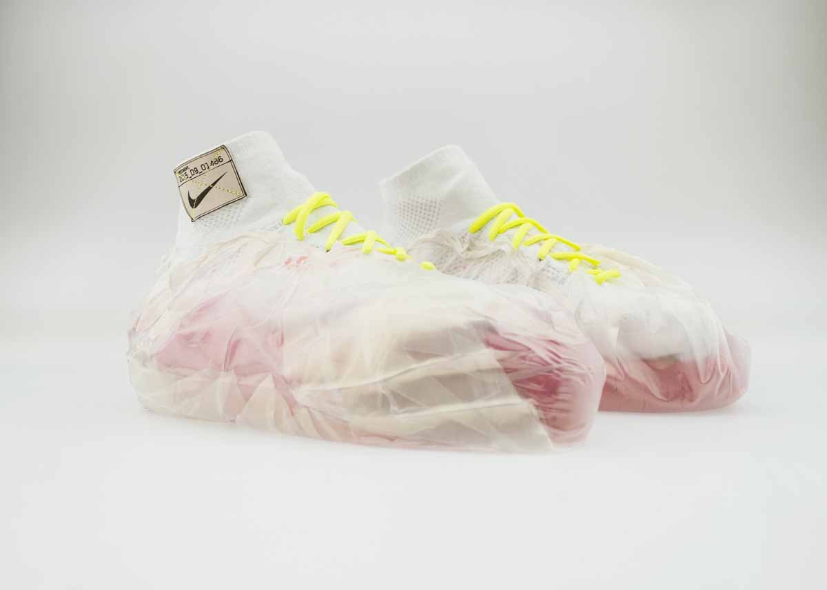 Plastic bags filled with kinetic sand are wrapped around these shoes for impact protection.