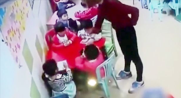 A nursery school teacher has been fired after she was caught slapping her talkative young pupils in class