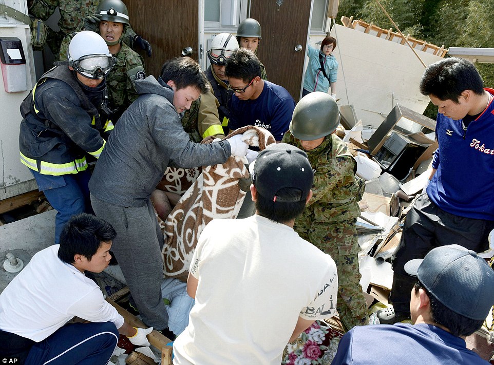 Emergency: Japanese government spokesman Yoshihide Suga said 1,500 people were injured by the twin quakes, and he promised to mobilise 20,000 troops to help people affected 