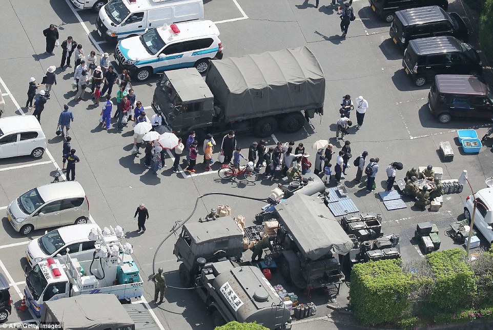 Bird's eye view: An aerial view shows residents forming a queue to receive meals from defense forces soldiers at the Mashiki town hall