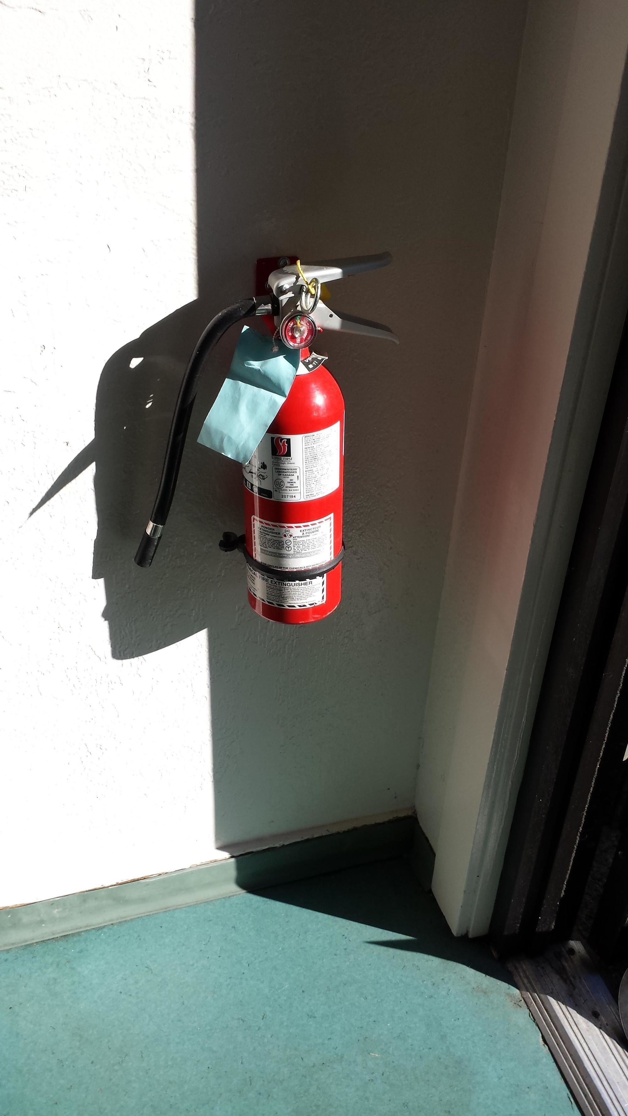 This fire extinguisher's shadow looks like a grouchy man's face.