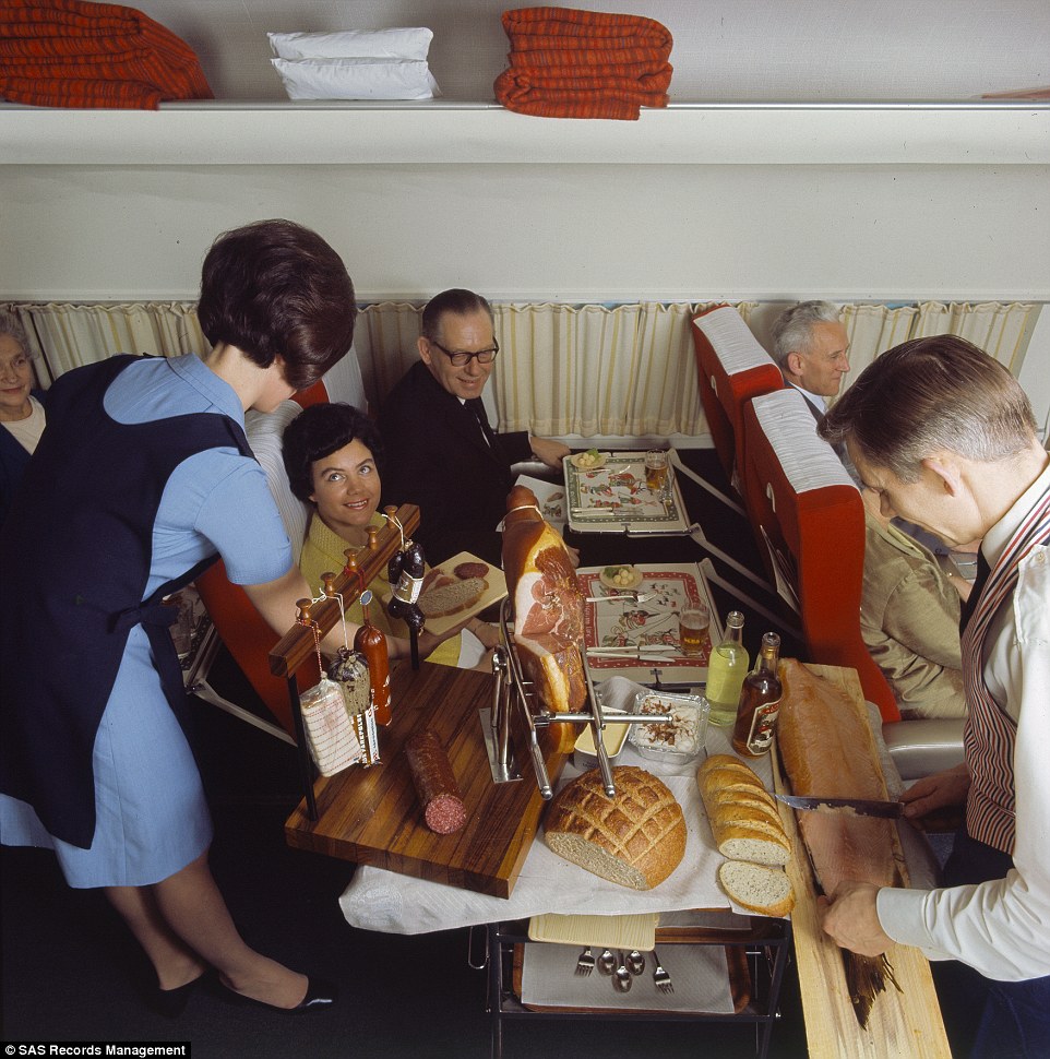 Another view of the food cart in 1969 shows a member of the crew filleting portions of salmon while another offers up a plate of salami with crusty bread