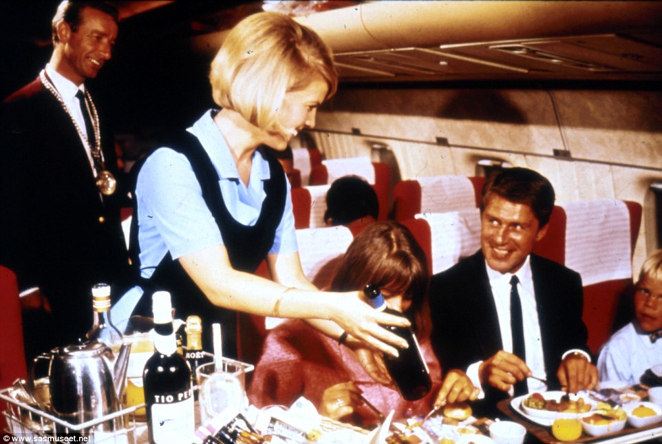 In the 1970s, it seems, Scandinavian Airlines still hired a sommelier to work the flights. Above, one is seen standing in the back while his colleague presents a wine