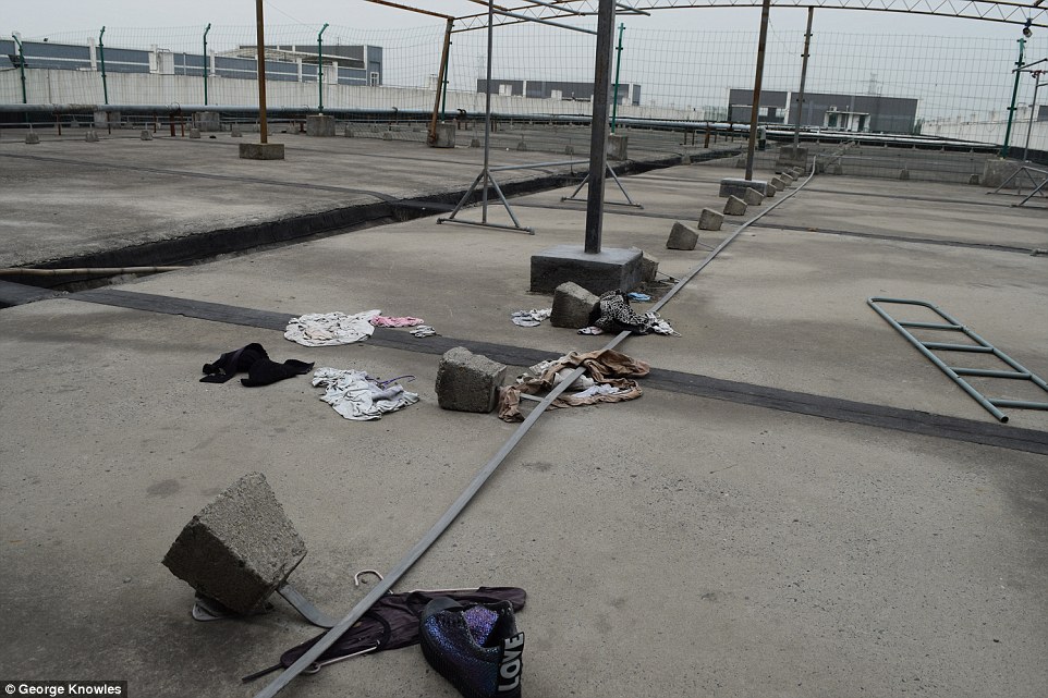 Divide: The men's and women's dormitory blocks are strictly segregated with a padlocked high fence separating the shared drying areas for laundry on the dormitory rooftop and throughout the building we entered we saw mementos of the harsh lives once lived here