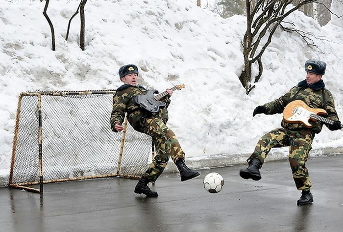 Guitars and soccer are a favorite past times of the military men. 