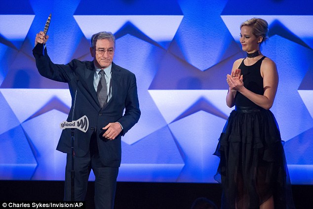 Victorious: Robert held his award up proudly as his Silver Linings co-star watched on 